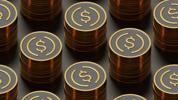 Stacks of metal coins with circles and a dollar sign in the middle.
