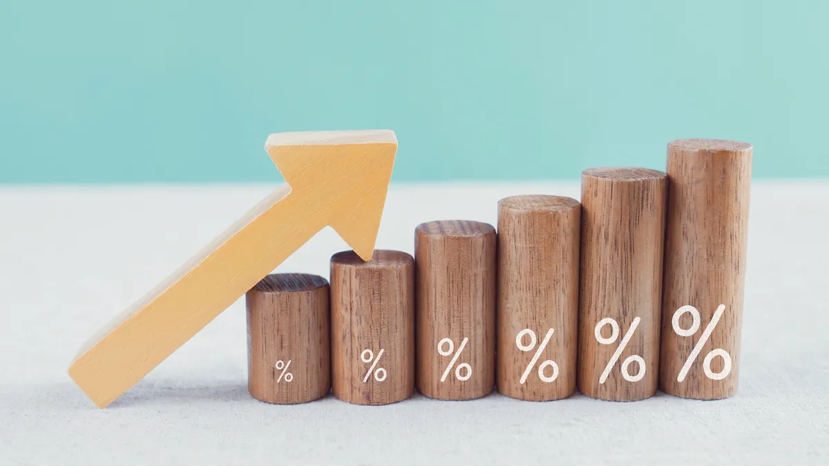 Wooden blocks with the percentage sign in front and an arrow pointing up