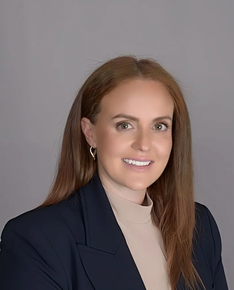 A head and shoulder photo of a person against a gray background.