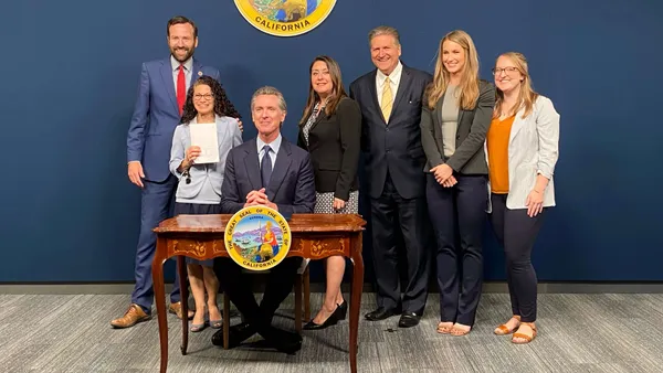 Gov. Gavin Newsom (seated) signs SB 54 on June 30, 2022. State Sen. Ben Allen far left. Assembywoman Luz Rivas to Newsom's right.