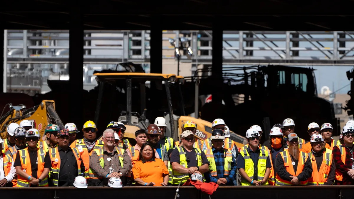 Construction workers listen to a speech from US President Joe Biden at Intel Ocotillo Campus on March 20, 2024 in Chandler, Arizona.