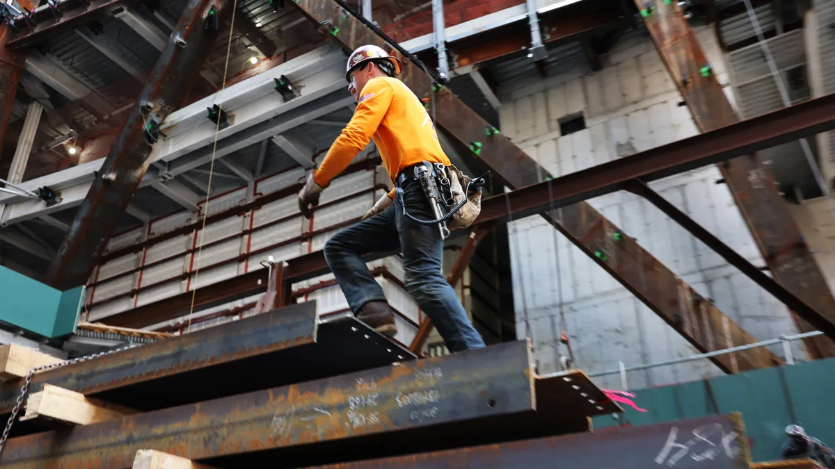 A construction worker walks across a job site.