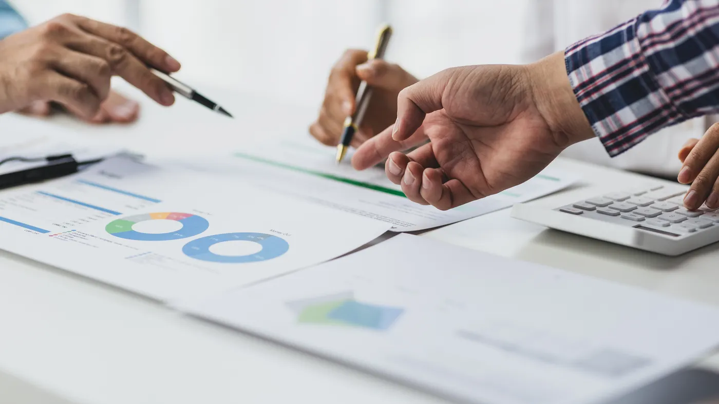 Meeting to discuss market situation analysis using financial charts in business reports