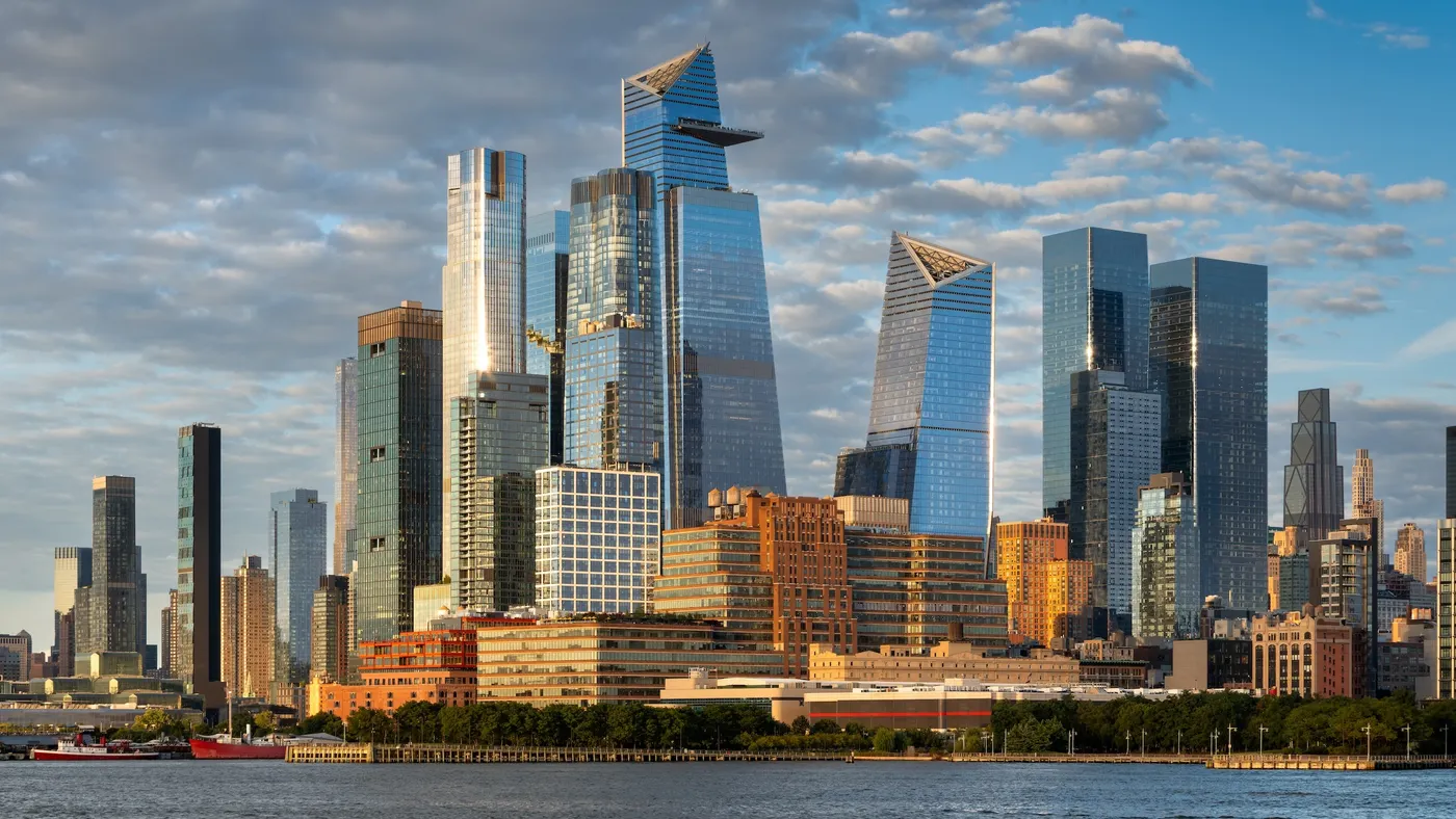 Tall buildings with body of water in the foreground.