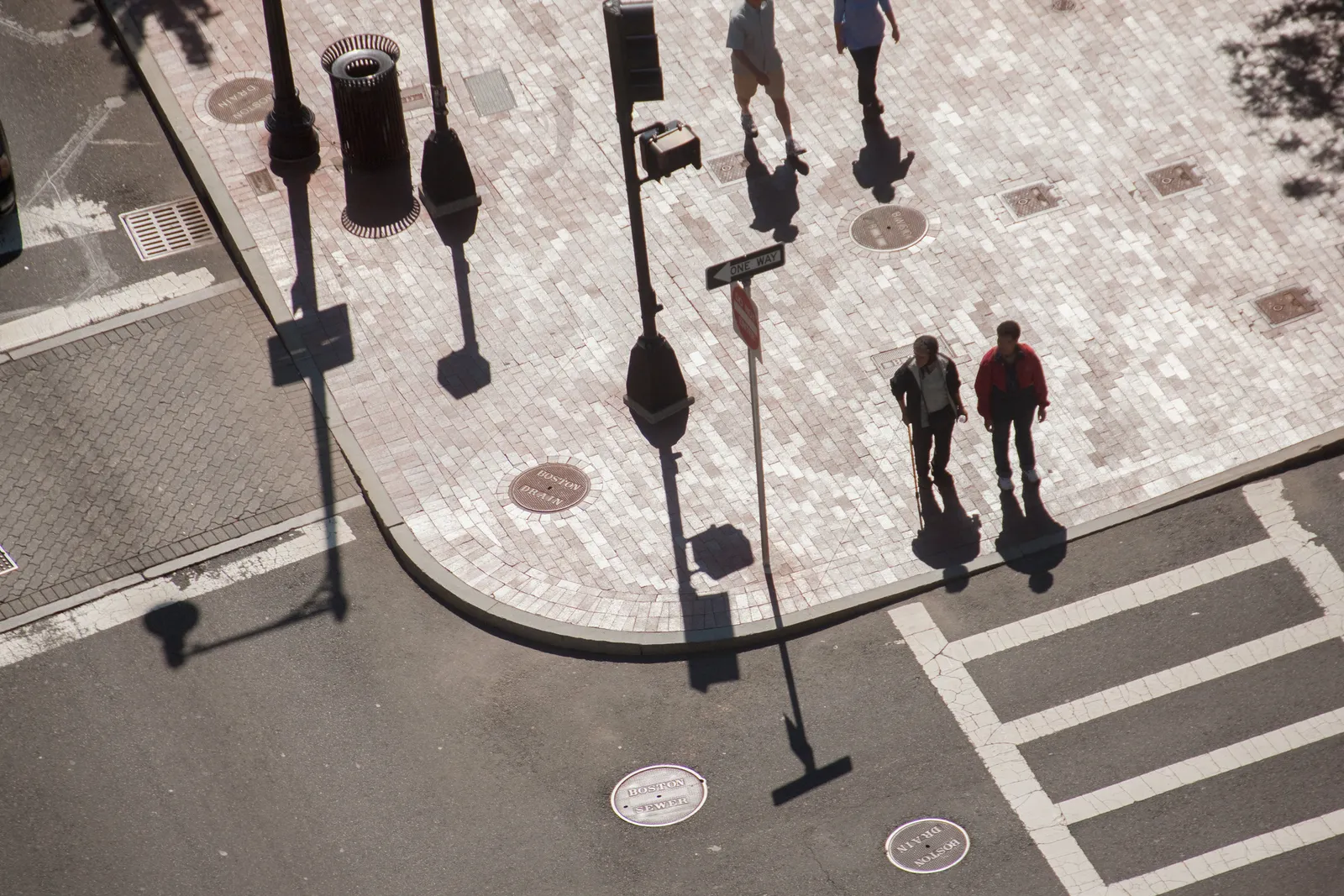 Overhead view of pedestrians at a street corner in Boston.