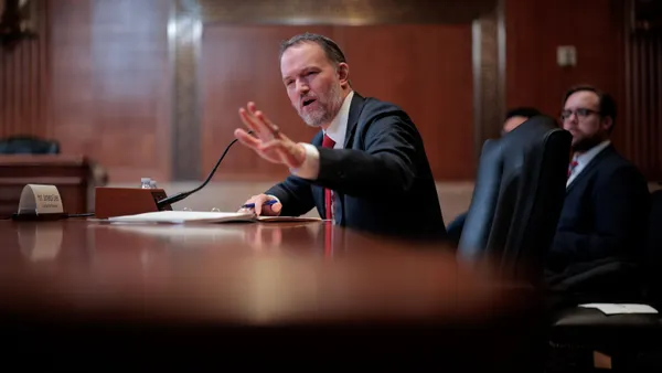 U.S. Trade Representative Jamieson Greer delivers remarks while sitting at a desk