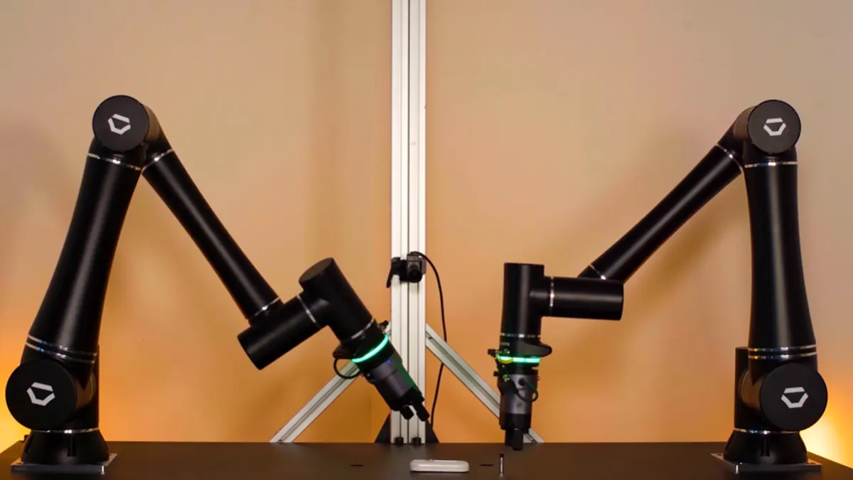 Standard Bots robotic arms demonstrate grabbing and picking up items.