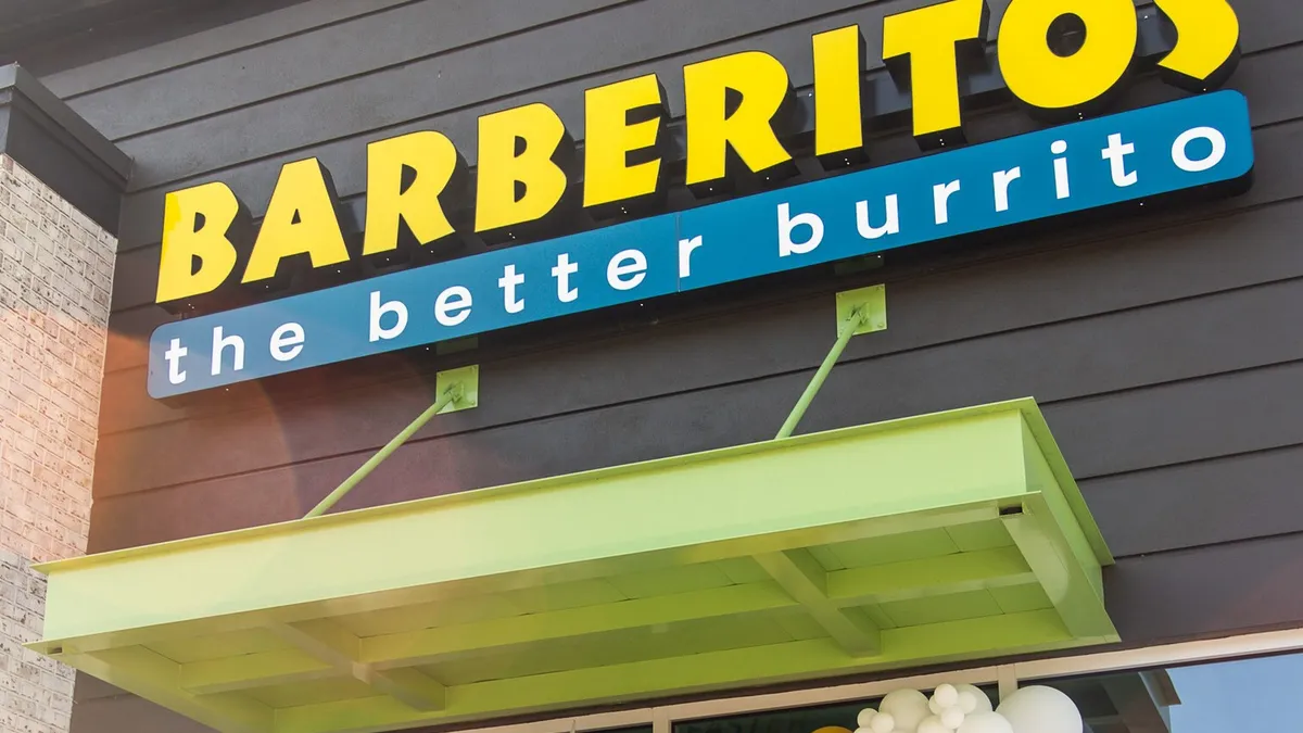 A building with a brown facade and a yellow sign that says "Barberitos."