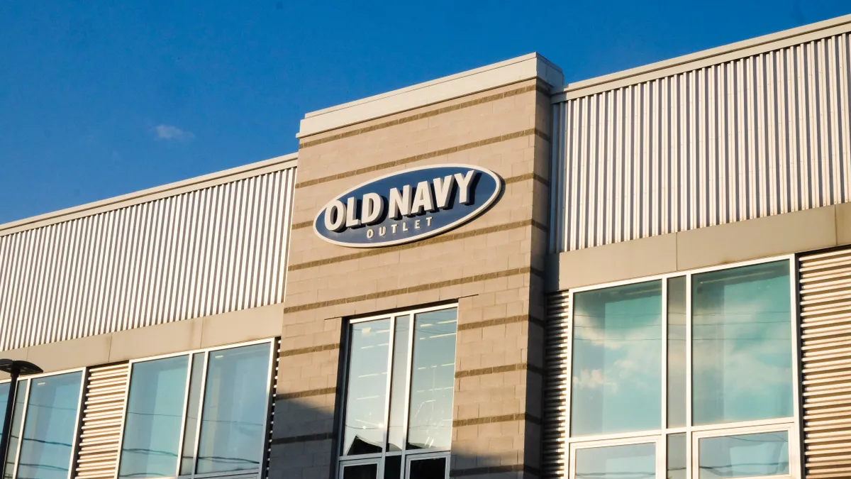 Sun shines on an Old Navy store front, under bright blue sky.