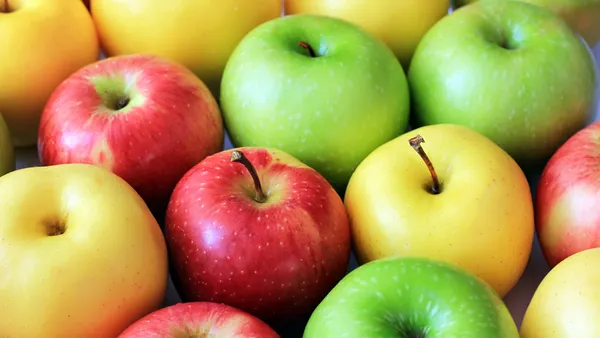 a close up of green and red apples