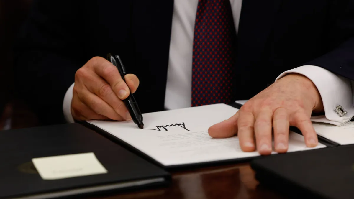 Closeup of president donald trump's signature on an executive order.