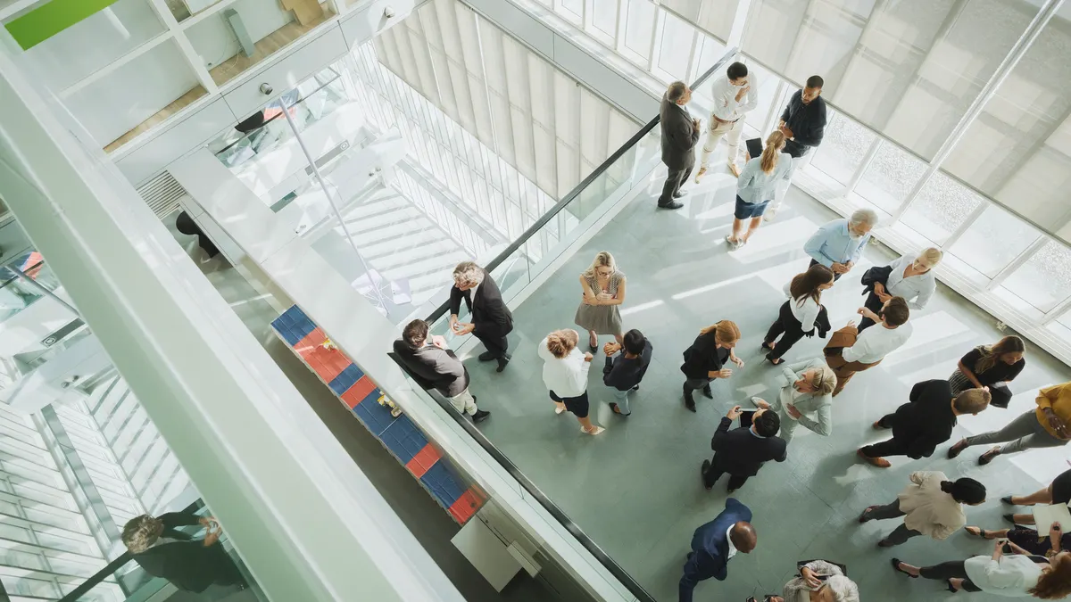 A view from up of a floor of a busy conference center.