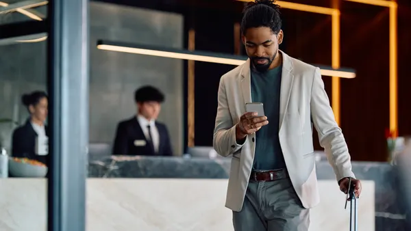 man using mobile phone while arriving at the hotel