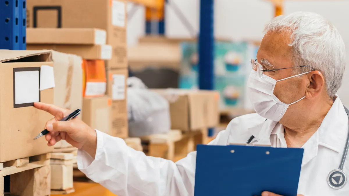 Senior doctor checking medical stock in a warehouse