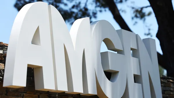 Large letters spelling Amgen are seen by a wall