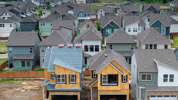 An aerial view of houses in various stages of construction.