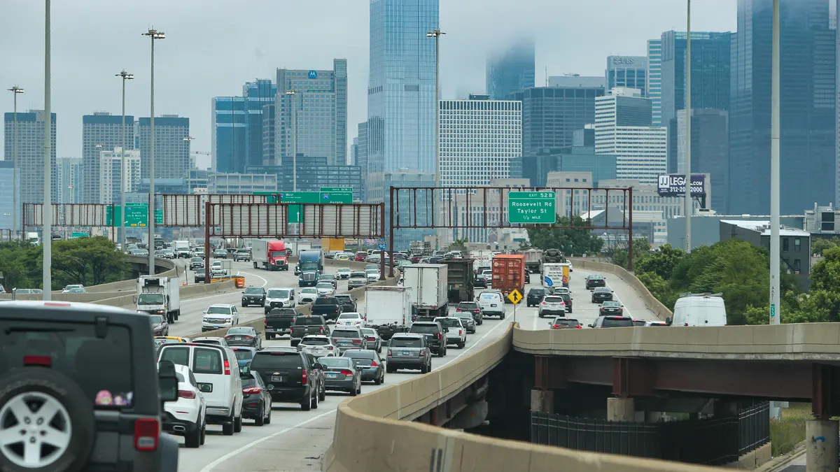 Traffic backed up on a highway in Chicago in 2023 with the cityscape in the distance.