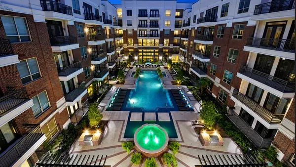 Mid-rise apartment surrounding courtyard and pool