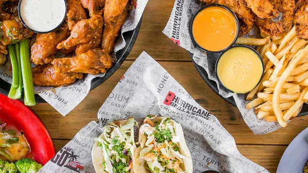 An image of chicken wings, tacos, French fries and chicken tenders from Hurricane Grill & Wings