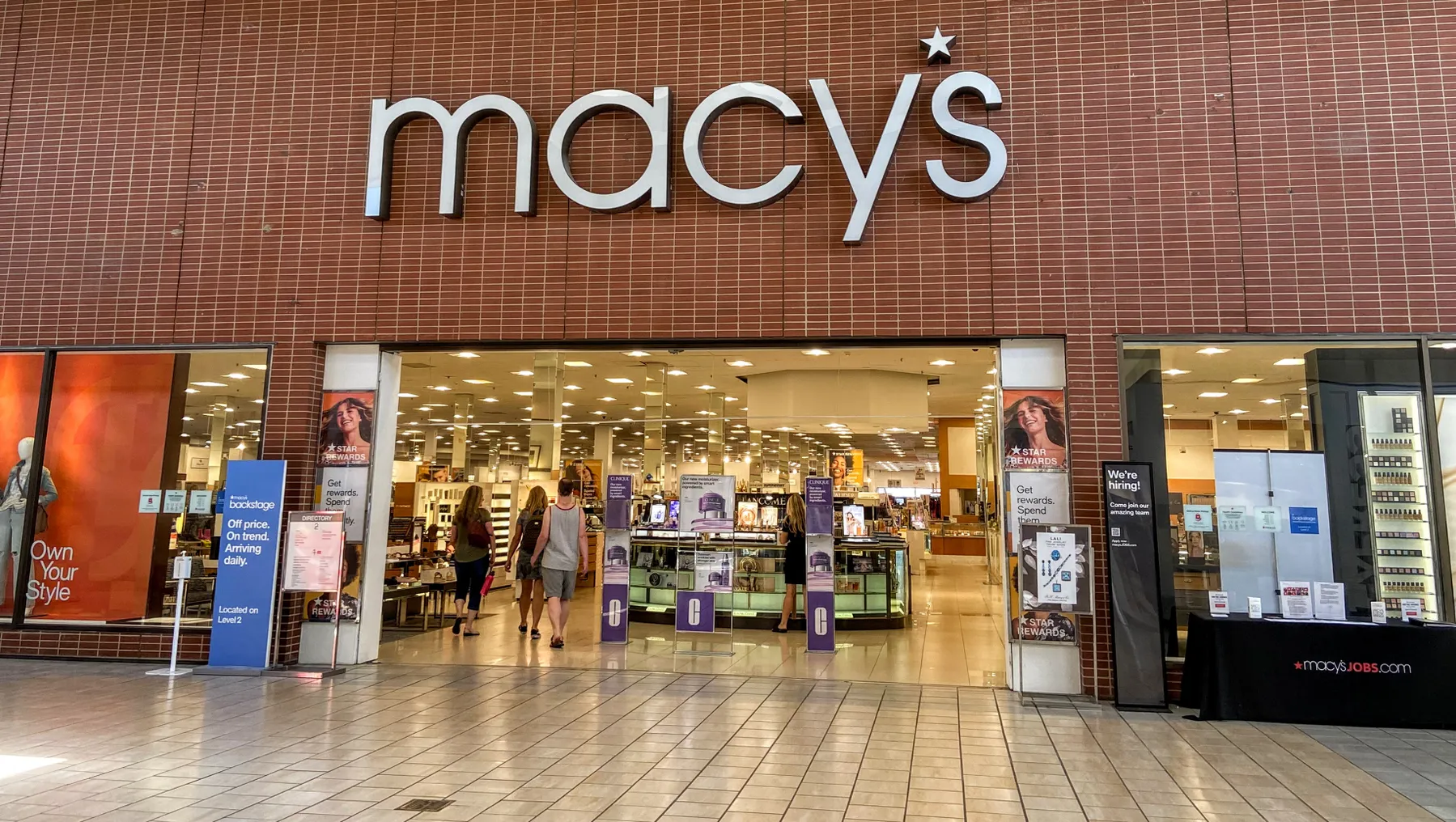 A red-brick facade mall entrance to a Macy's store.