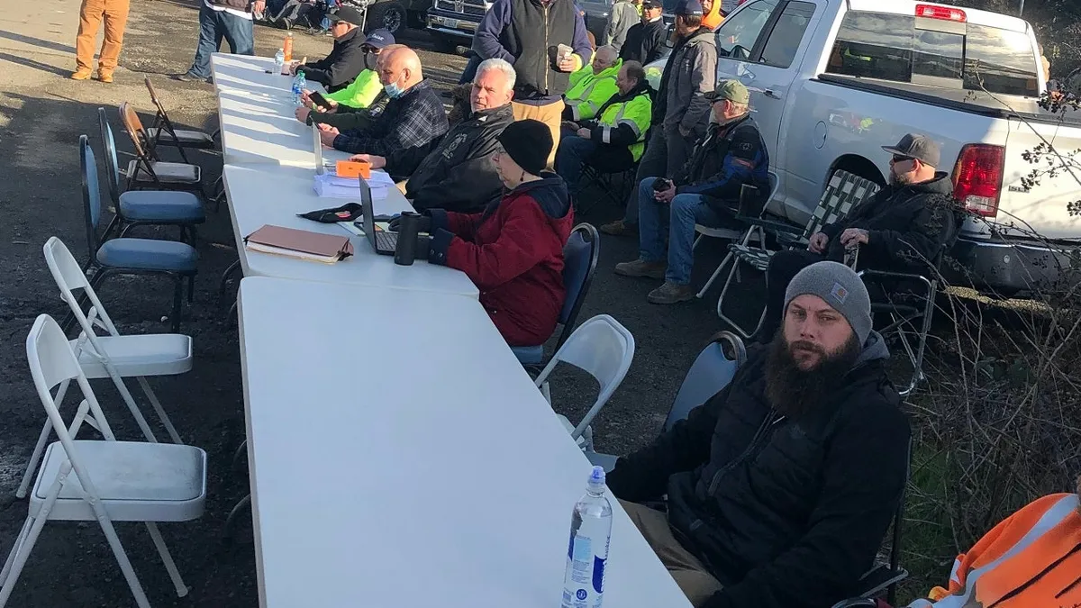 Teamsters Local 174 strikes in front of Gary Merlino Construction and sets up a negotiating table out front.