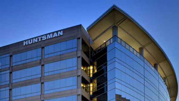 A building with windows, and the white Huntsman logo on its side.