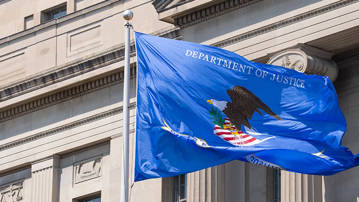 Department of Justice flag flies in the wind