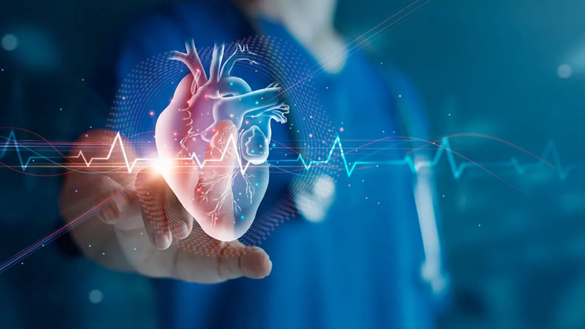 Medical professional in scrubs reaching out to touch heart with heartbeat lines.