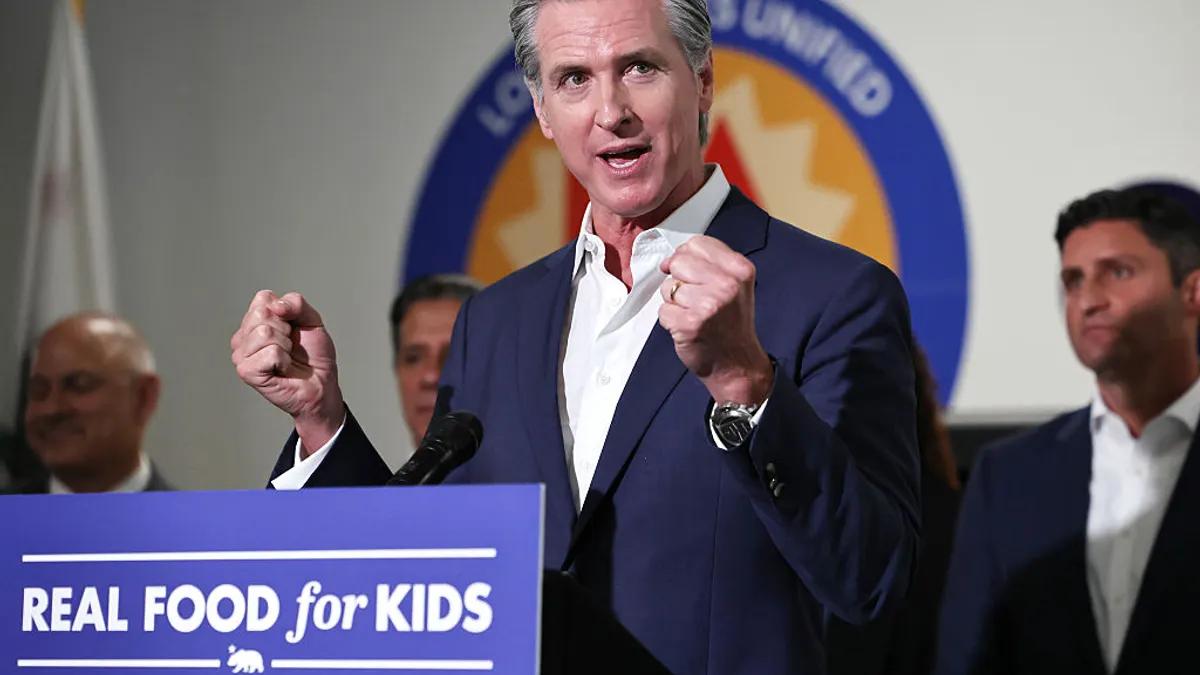 California Governor Gavin Newsom is seen speaking behind a podium