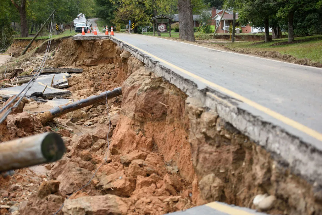 A lane of roadway is washed away and a power line is down.