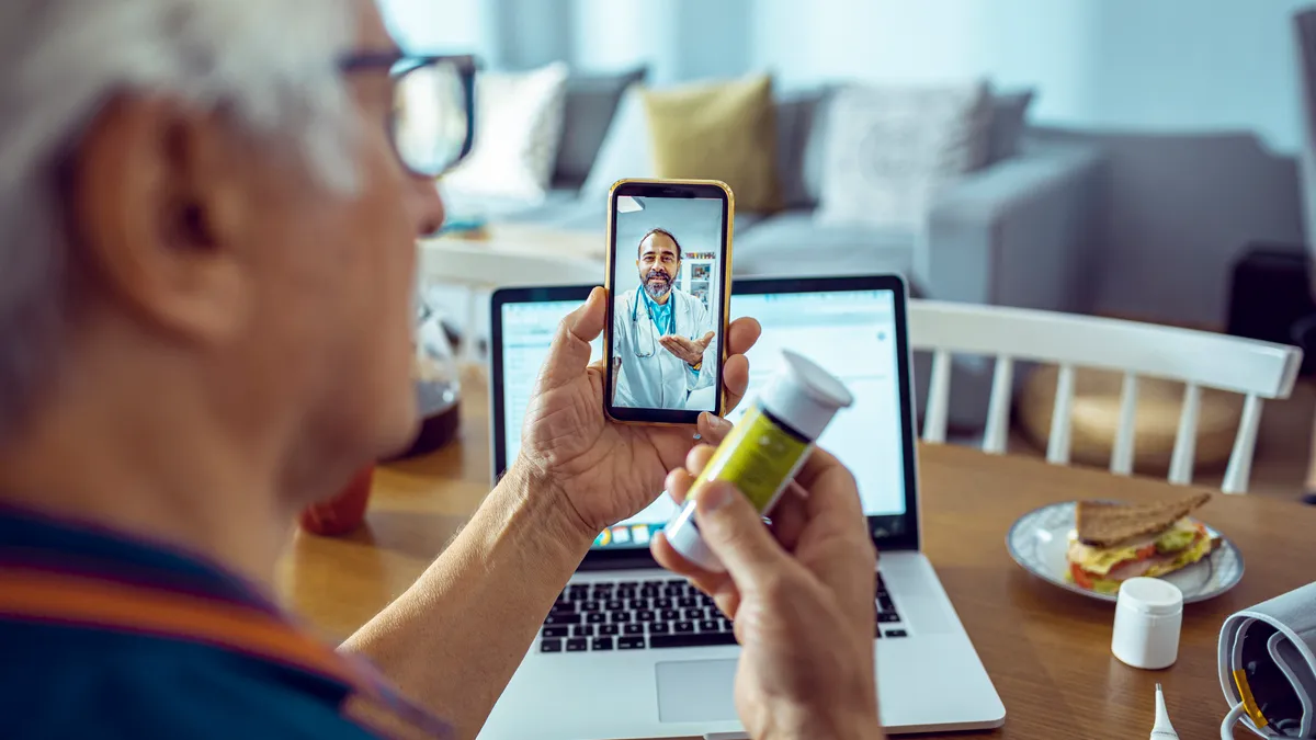 A patient speaks with their doctor via his mobile phone