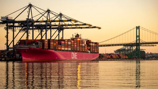 An ocean vessel at the Port of Los Angeles during sunrise