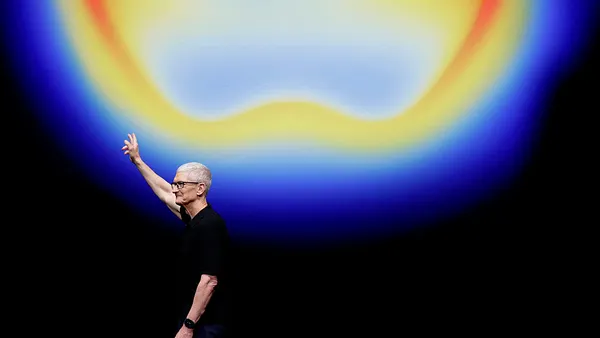 Apple CEO waves during a keynote conference