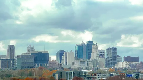 Downtown with tall buildings along a river.
