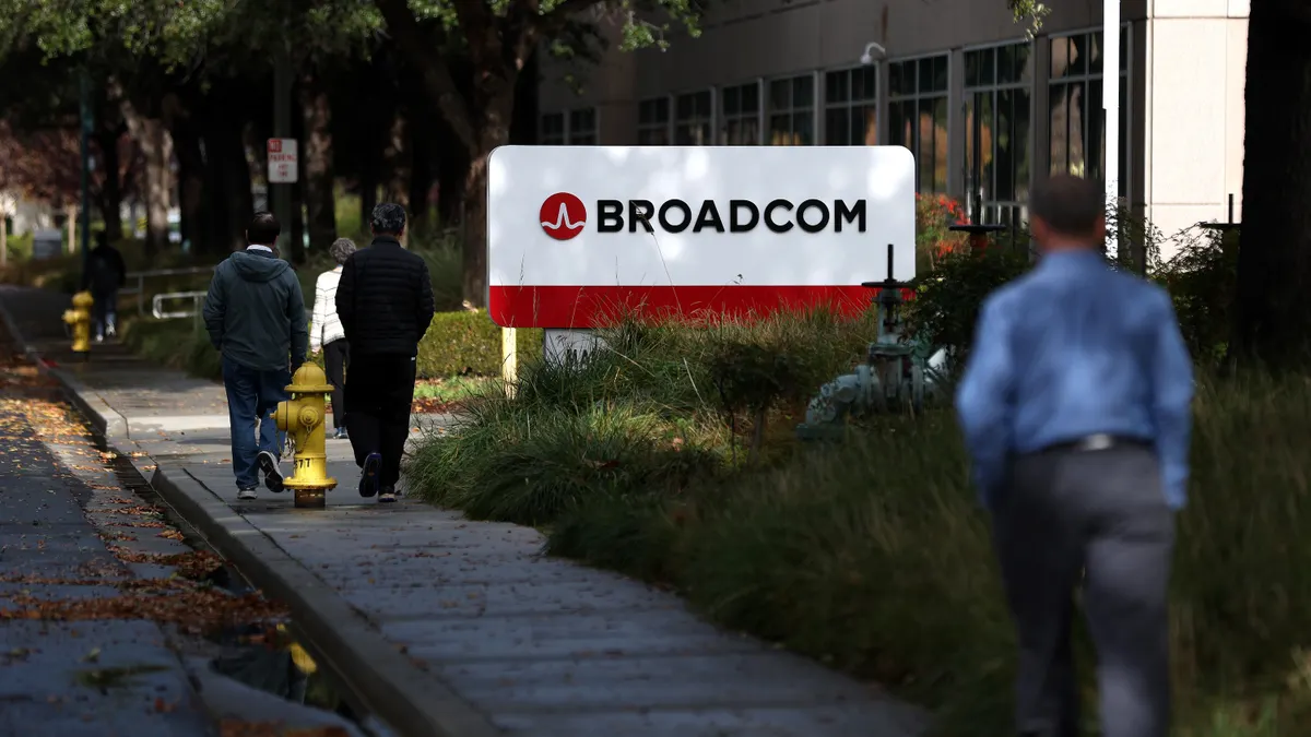 Pedestrians walk by a Broadcom sign in front of a the company's office on Dec. 12, 2024 in San Jose, California.