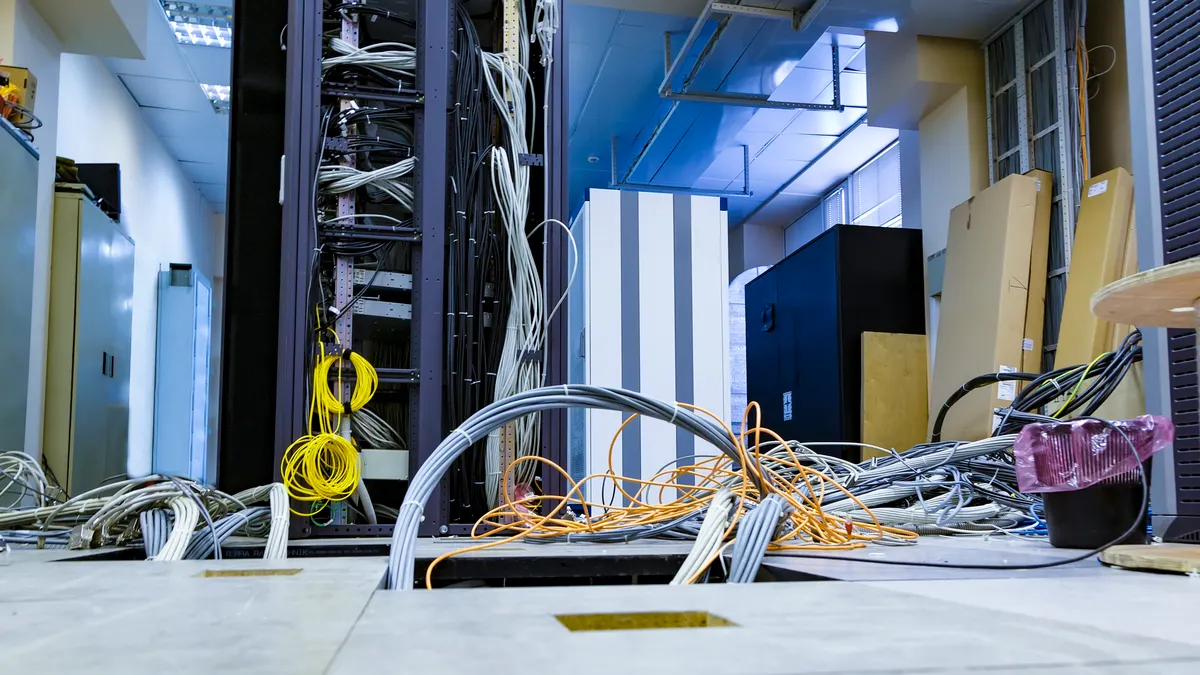 A raised floor and suction tool in the server room of a data center.