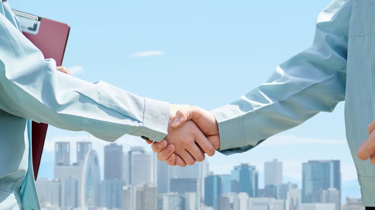 shaking hands against the backdrop of the city