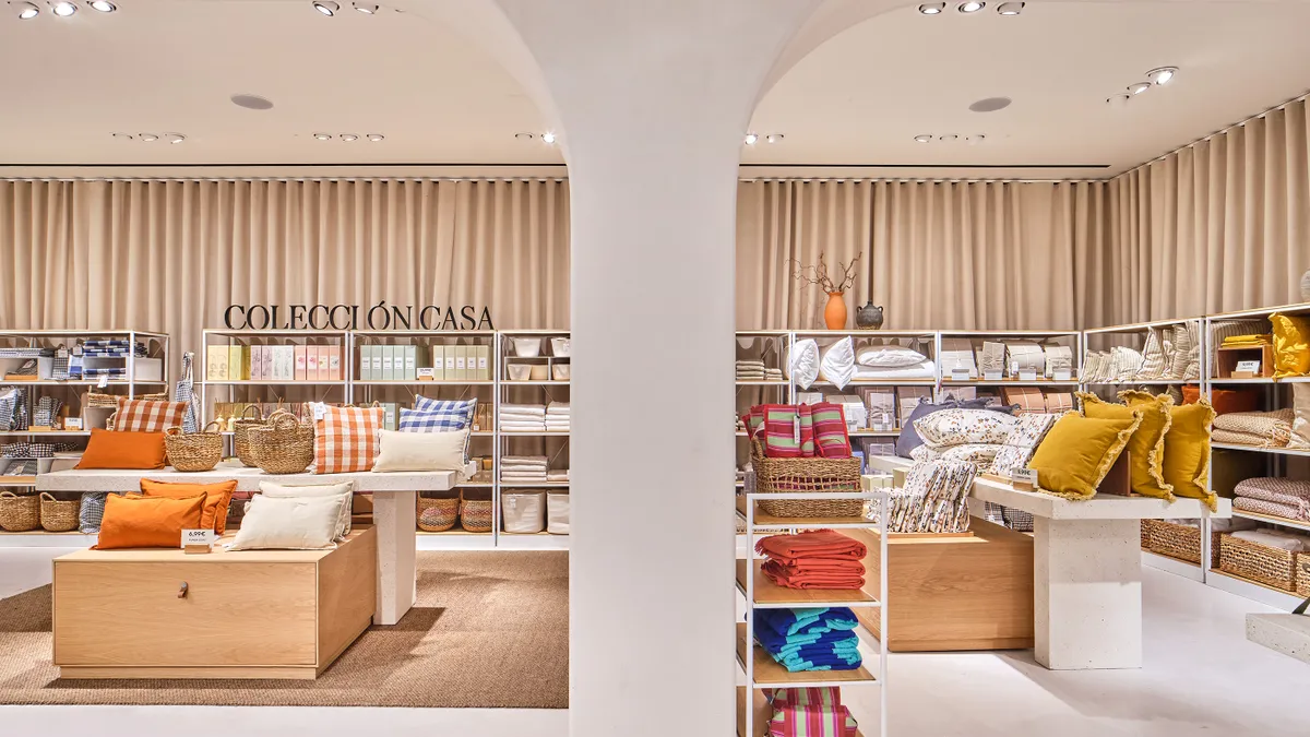 The interior of a Mango Home store. Shelves are lined with pillows, sheets, towels and various other homegoods.