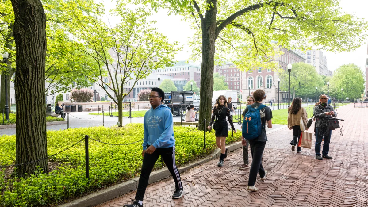 Students walk through the campus of Columbia University.