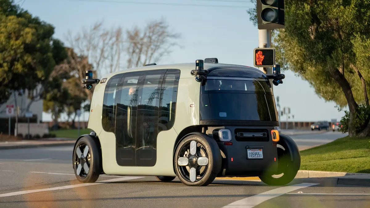 A Zoox robotaxi drives on a public road