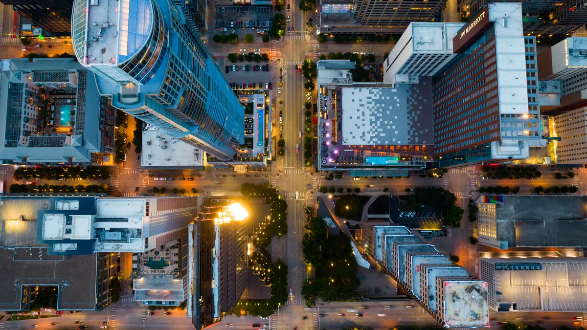 Aerial shot of city streets and tall buildings