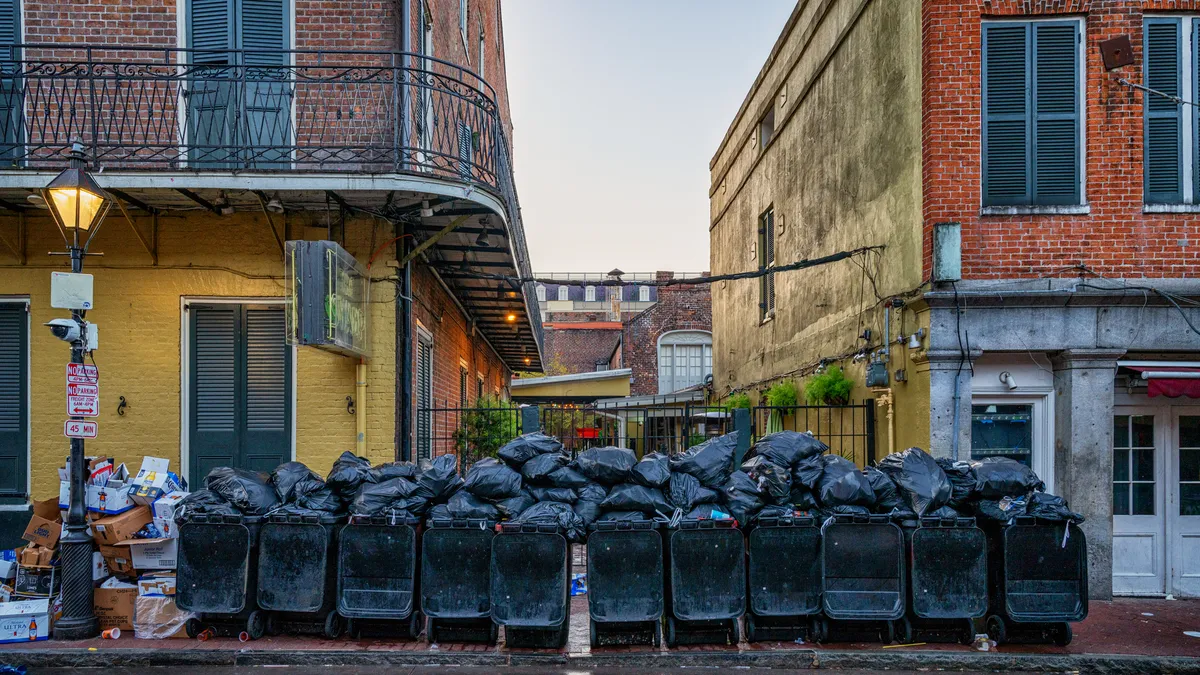 Trash bags piled up along Bourbon Street at sunrise on March 8, 2020.