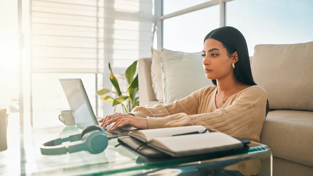 Shot of an young Latina woman working from home