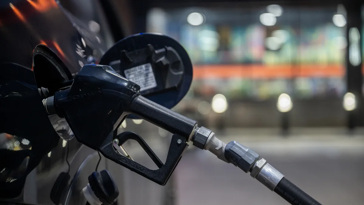 A photo of a car being fuelled up at a gas pump.