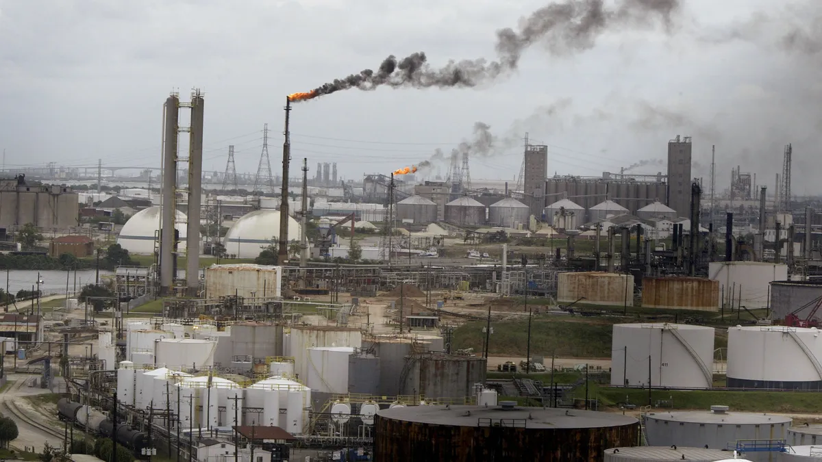 Long-distance view of gret oil refinery buildings stretch into the horizon.