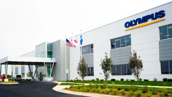 An image of a horizontal building with a driveway.