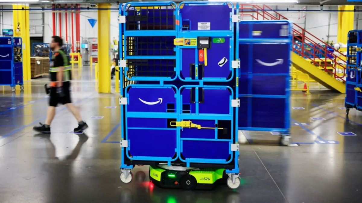 Amazon warehouse robot Proteus carries a tote inside a company facility.