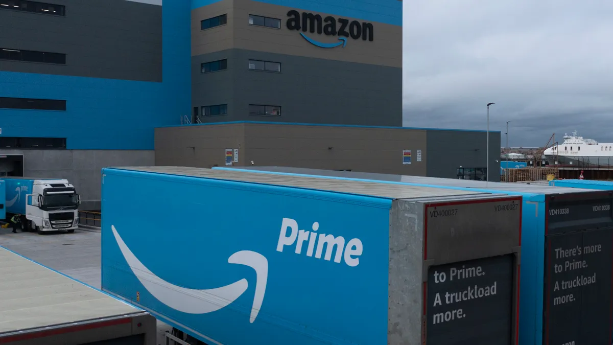 A blue Amazon Prime truck bearing the company's logo is parked outside one of its warehouse centers.