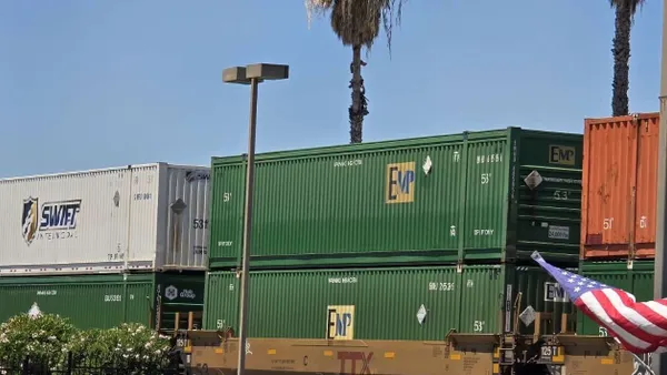 A row of containers onboard a rail train.