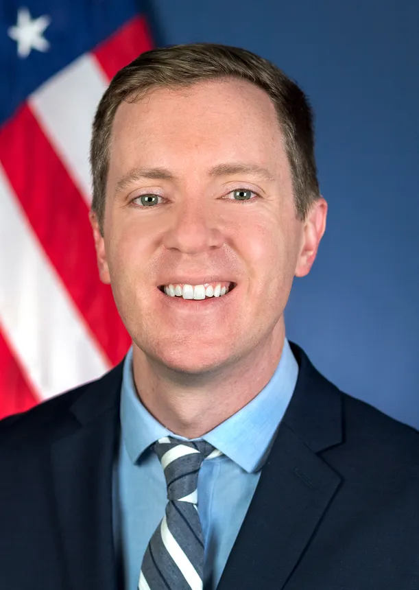 Headshot of a man in a suit.